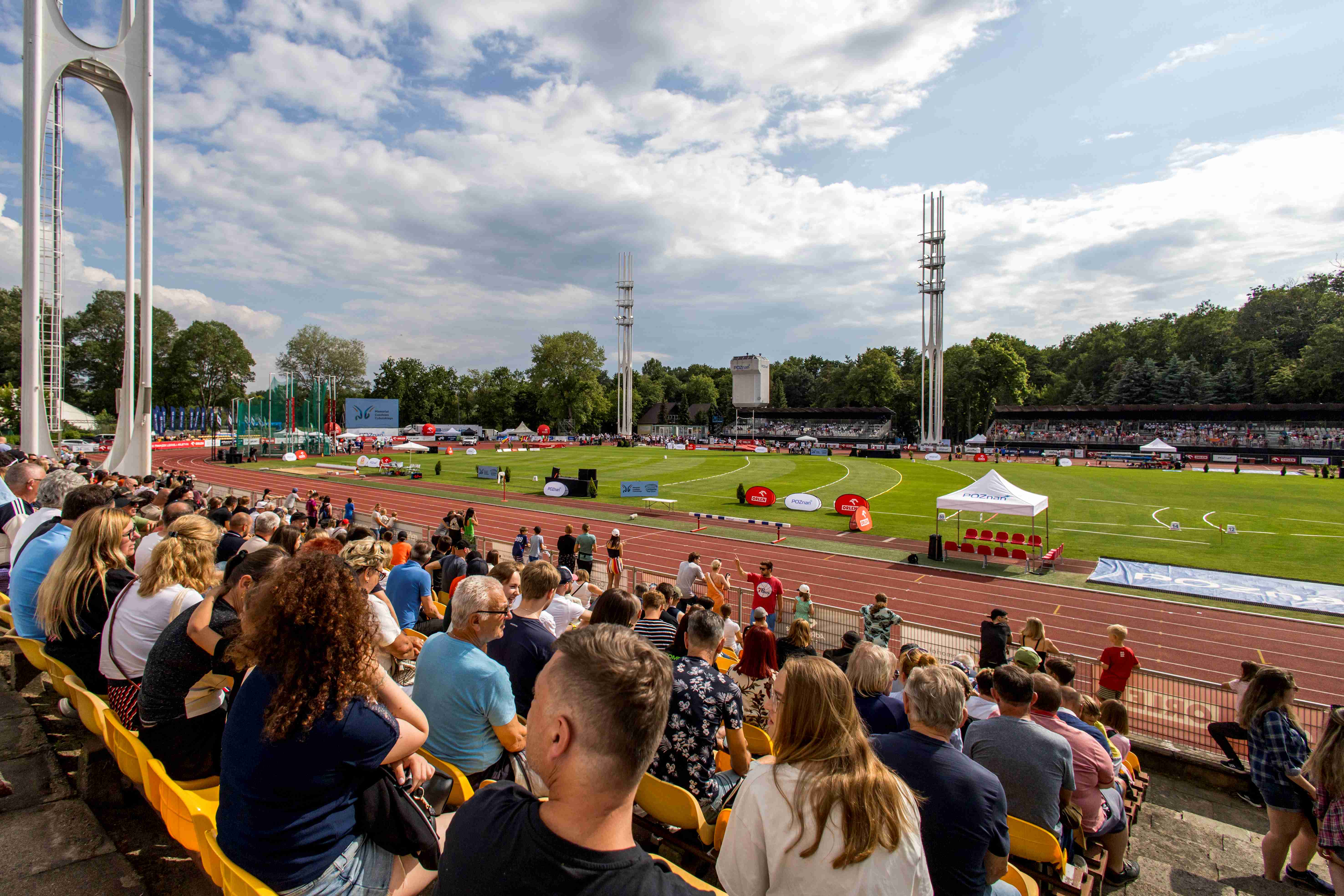 Fans sit in the stands of the athletics stadium.